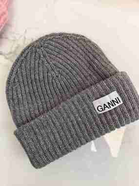 GANNI Black Ribbed Cuff Beanie Signature Woven Logo Tag Knit Hat GANNI Fitted Wool Rib Knit Beanie | endource main image 2